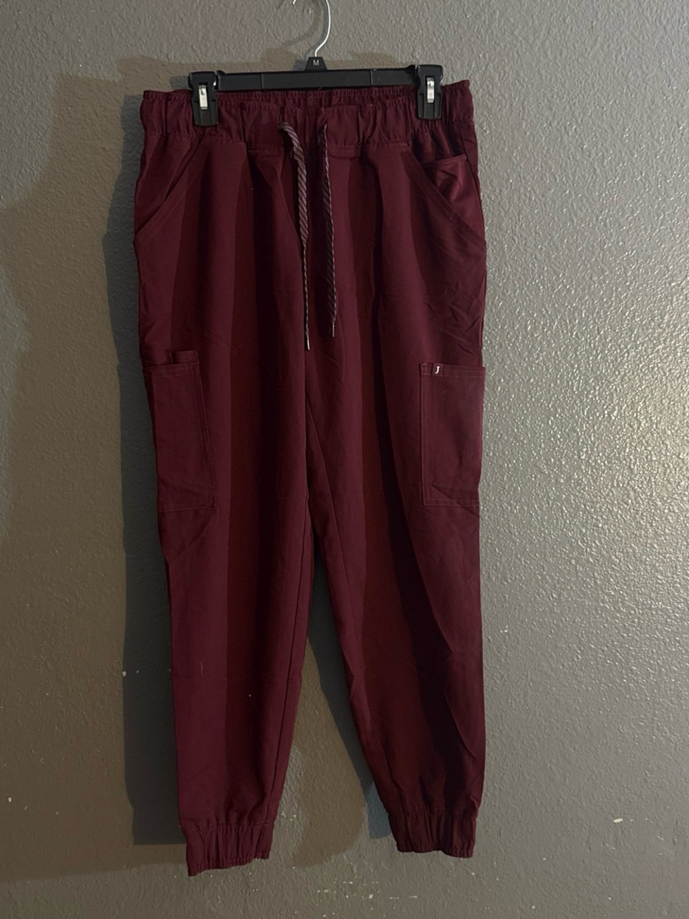 Jaanuu burgundy wine color  women’s scrub bottoms, taper fit